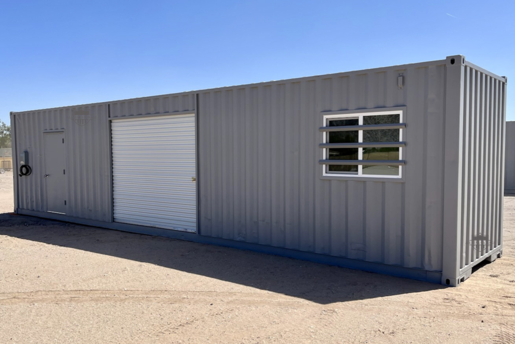 40ft Modified Shipping Container painted grey with window, side roll up door, walk door, and electric package.png