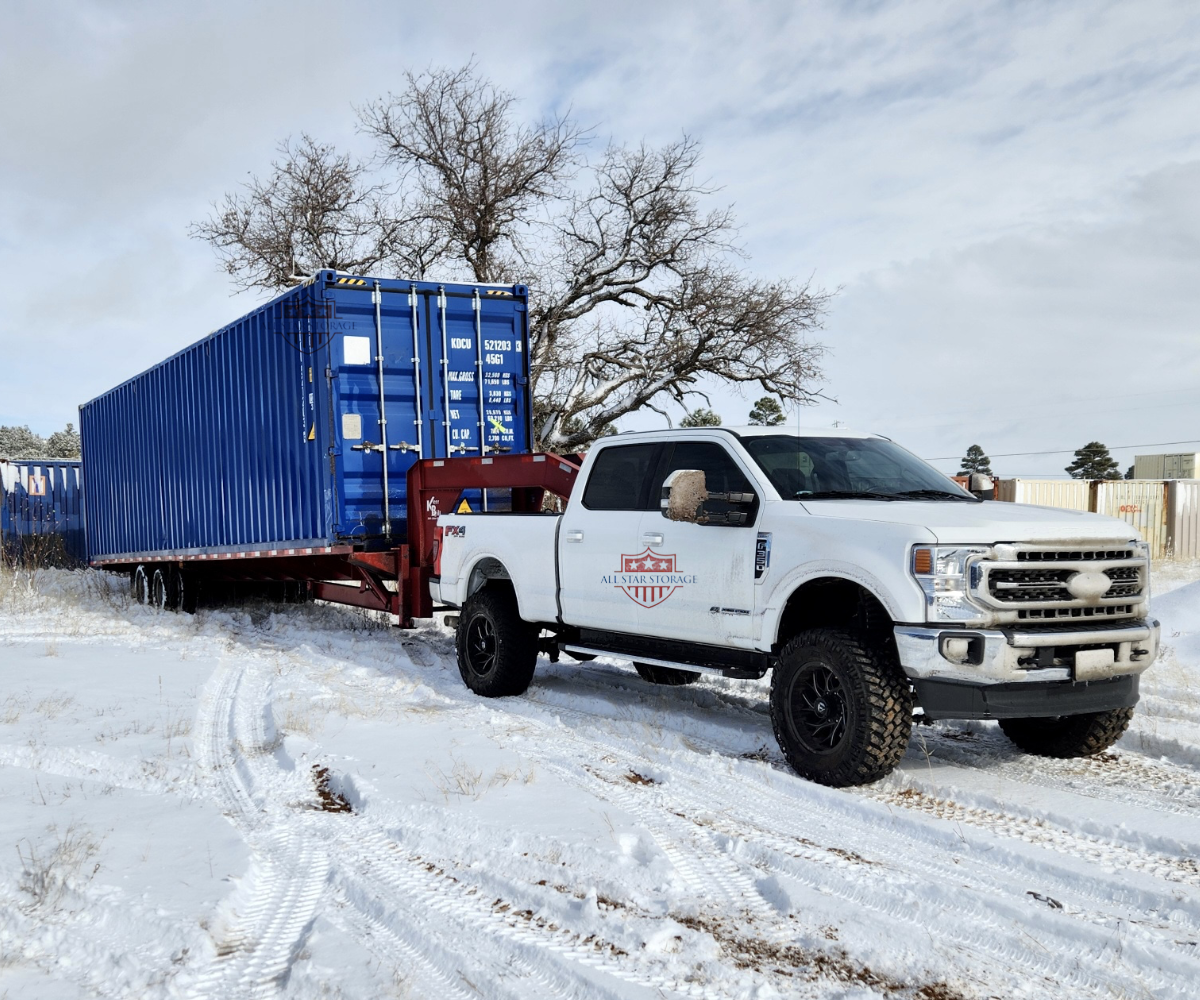 40ft High Cube One Trip Shipping Container Delivery on Tilt Trailer in Snow